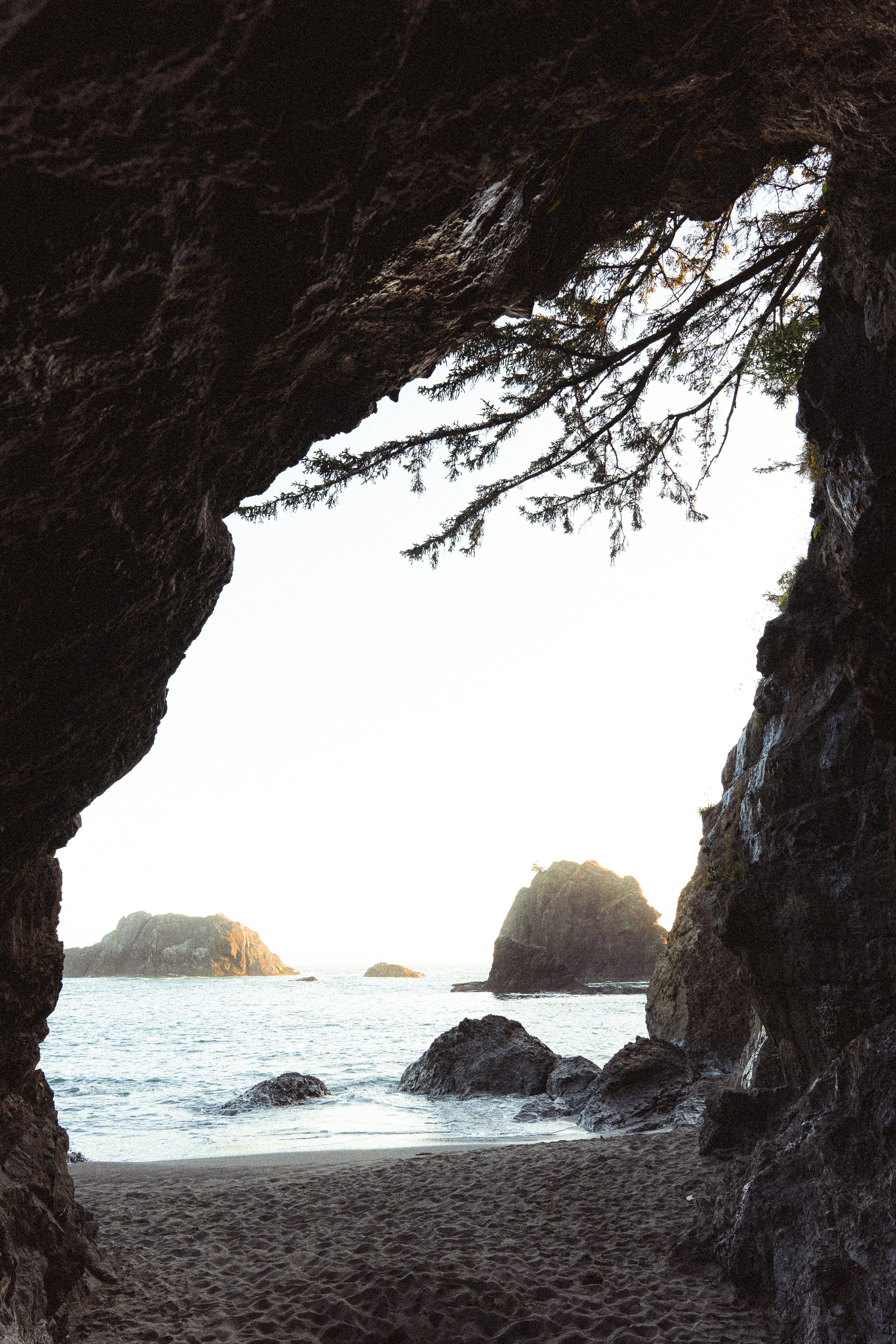 brown rock formation near body of water during daytime